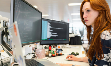Developer working with AI tools and code generation on computer screen